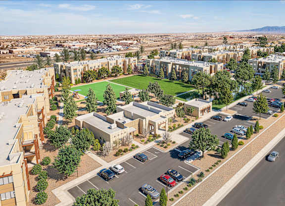 Aerial view of apartment buildings with parking and landscaping at Turquoise Trail Apartments, New Mexico, 87508