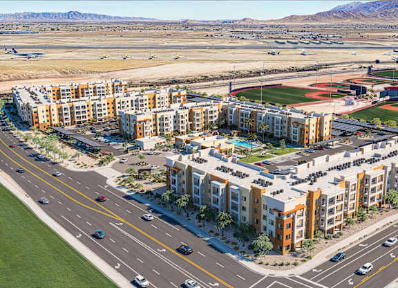 Aerial view of residential community with adjacent sports complex at Vivir at Ballpark Village Apartments, Goodyear