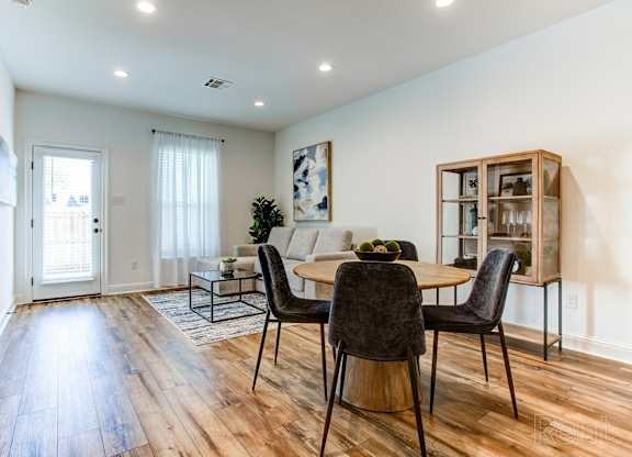 an open living room and dining room with a table and chairs