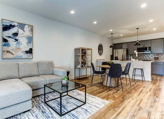 a living room with a couch and a table with chairs