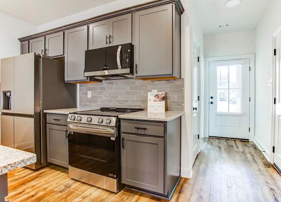 a kitchen with stainless steel appliances and white cabinets