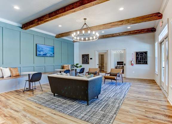 a living room with blue walls and wood floors and a couch