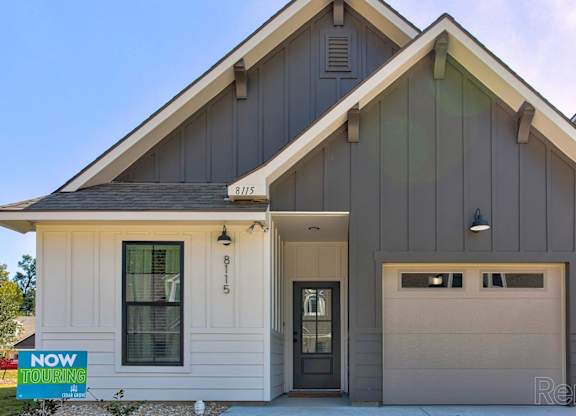 the front of a house with a garage door