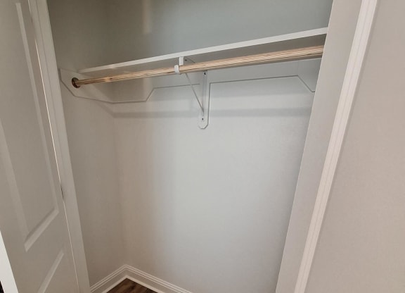 a small bathroom with a shower and a wooden floor