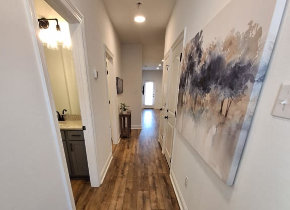a kitchen with a sink and a wood accent wall
