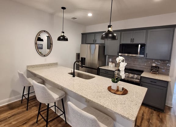 a view from above of a living room with a dining room table and a kitchen