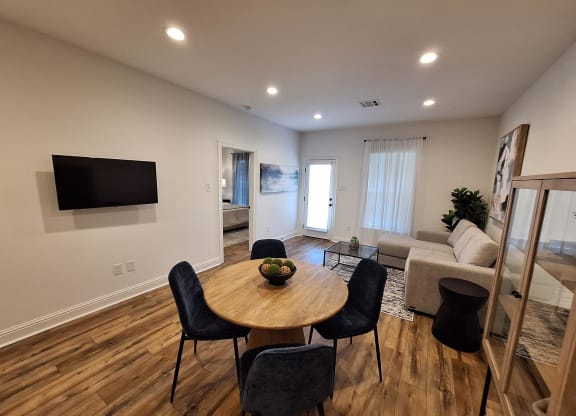 a living room with a table and chairs and a couch