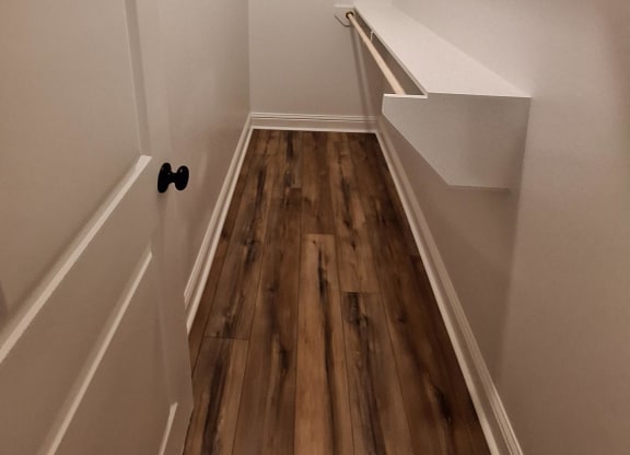 a large white room with a wooden wall and a white sink