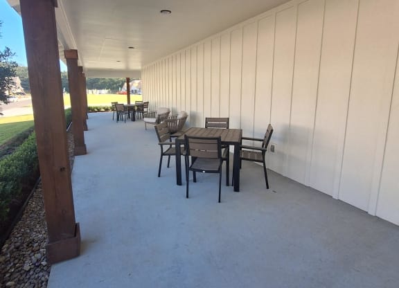 a long hallway with benches on the side of a building