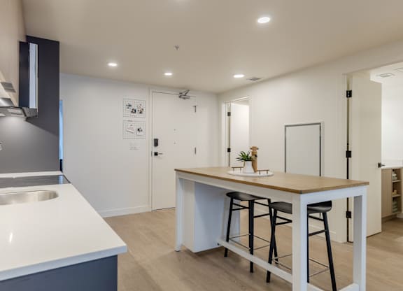A modern kitchen with a bar stool and a countertop.