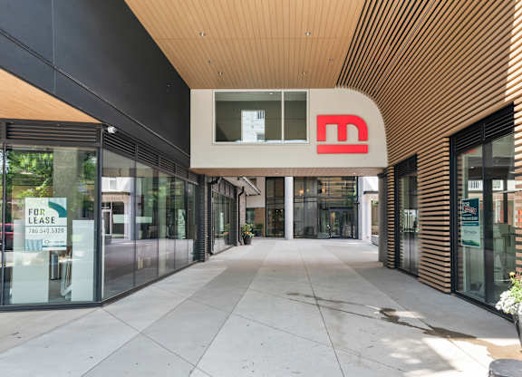 The entrance to a building with a red logo on the ceiling.