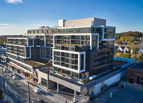 A large modern building with a lot of windows and balconies.
