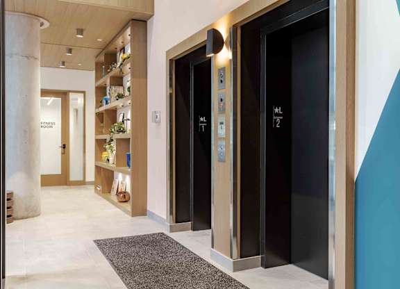 A hallway with elevators numbered 1 and 2.
