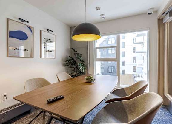 A conference room with a long table and chairs.