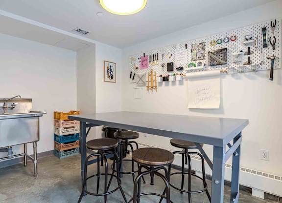A kitchen area with a bar and stools.