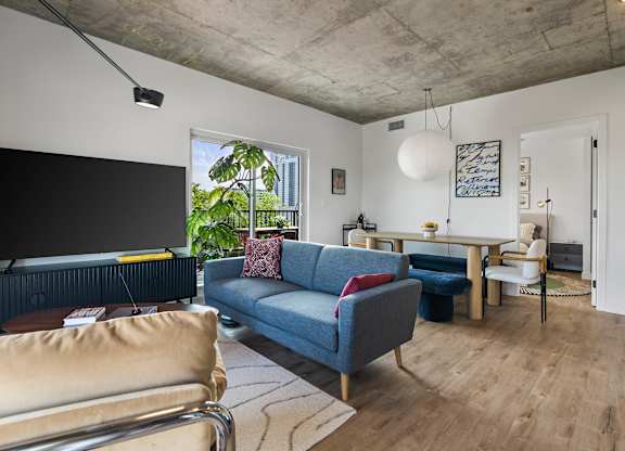 A living room with a blue couch and a television.