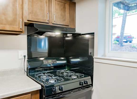 A black stove top oven with a glass door is in a kitchen.