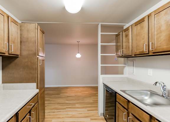 A kitchen with wooden cabinets and a white countertop.