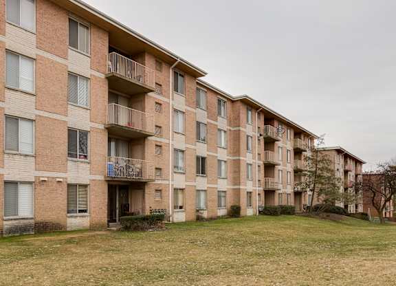 Apartment building with balconies and windows.