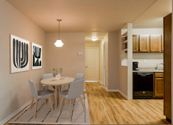 A dining room with a table and chairs.