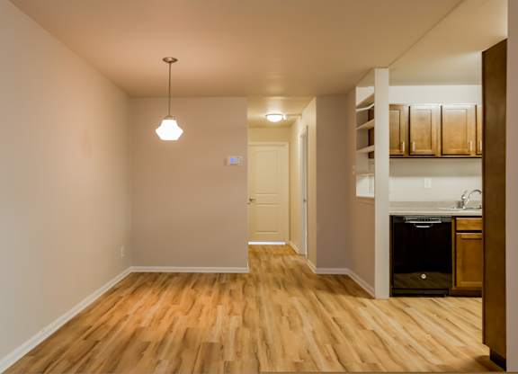 A room with wooden floors and a white door.
