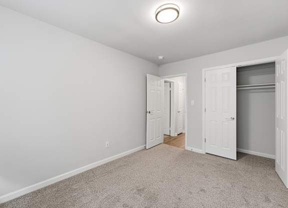 A room with white walls and a carpeted floor.