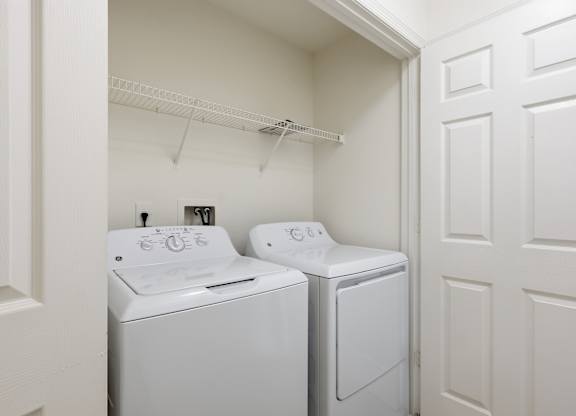 A white laundry room with a washer and dryer.