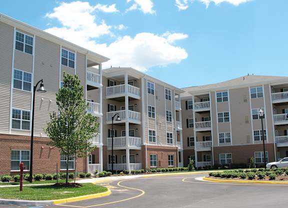 Apartment complex with a circular driveway in front.