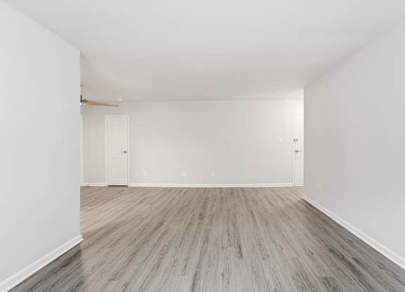 A room with a wooden floor and white walls.