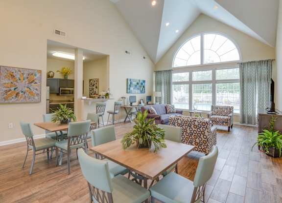 A dining room with a table and chairs.