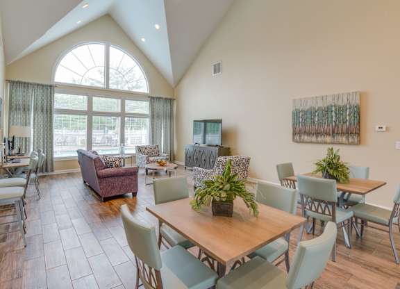 A dining room with a table and chairs.