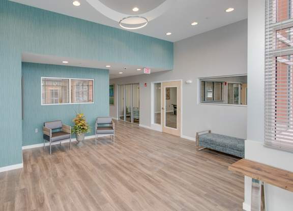 A room with a blue wall and wooden flooring.