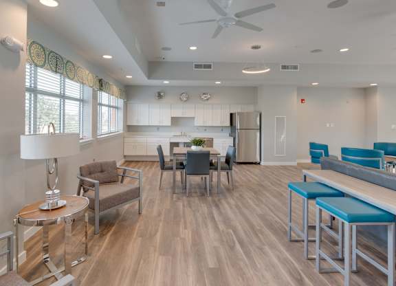 A modern kitchen and dining area with a wooden floor and white walls.