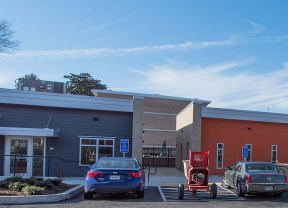 A parking lot with cars and a building in the background.