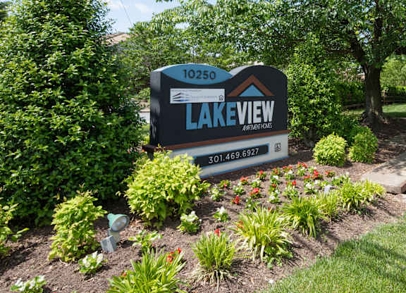 A sign for Lakeview Arboretum is displayed in a garden.