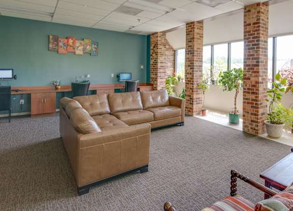 A living room with a brown couch and a television.