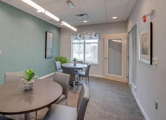 A conference room with a table and chairs.