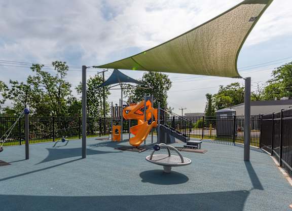 A playground with a swing set and a slide.