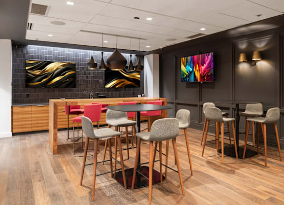A modern dining room with a wooden table and chairs at Clayton on the Park Apartments, Missouri