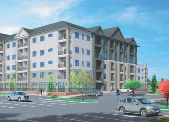 A large apartment building with a parking lot in front.