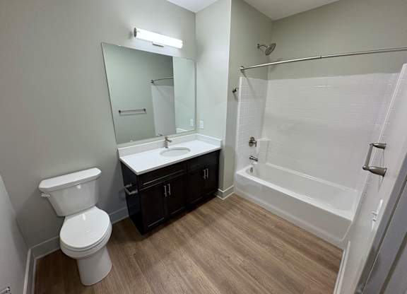 A white toilet sits next to a sink in a bathroom.