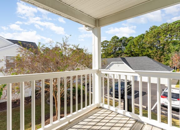 the view from the deck of a home with a white railing