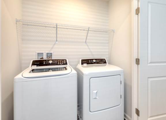 Two white front load washing machines in a laundry room at The Mark Townhomes Apartments, Harrisonburg, VA