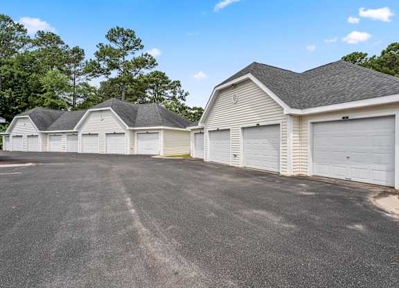 A row of garages with a clear blue sky above.