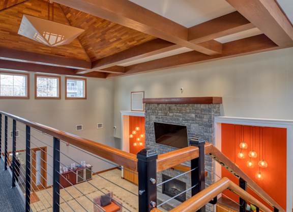 A fireplace with a wooden mantle and a fire burning in it.