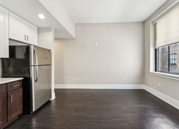 a kitchen with a refrigerator freezer next to a window
