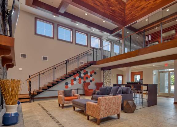 A large open space with a staircase and a couch.