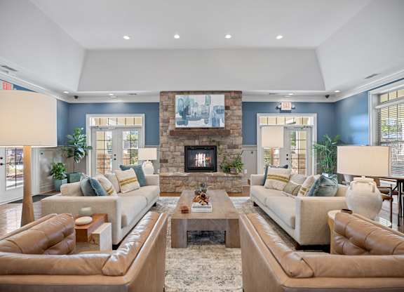 A living room with two couches and a fireplace.