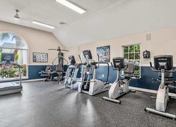 A gym with treadmills, exercise bikes, and elliptical machines.
