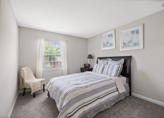 a bedroom with a bed and a chair